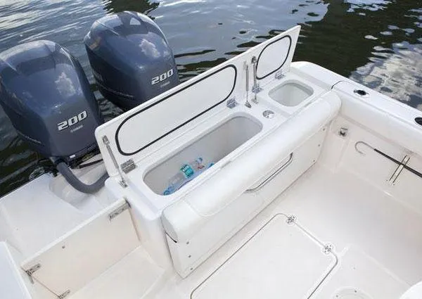 Slide: The Image of 2013 Pursuit C 260 Center Console boat with twin 200 HP engines and open storage compartment. - 38