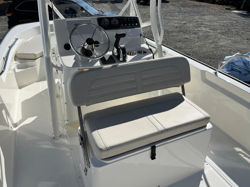 Slide: The Image of 2025 Boston Whaler 190 Montauk boat interior with steering console and seating. - 10