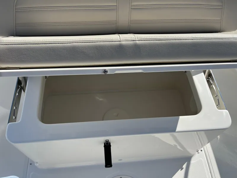 Slide: The Image of 2025 Boston Whaler 190 Montauk storage compartment with cushioned seating. - 11