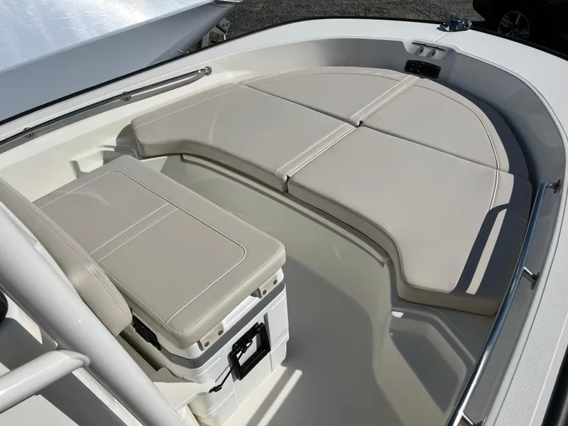 Slide: The Image of 2025 Boston Whaler 190 Montauk boat interior with cushioned seating and storage. - 15