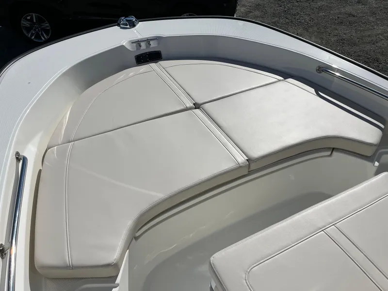 Slide: The Image of 2025 Boston Whaler 190 Montauk boat interior with cushioned seating area. - 16