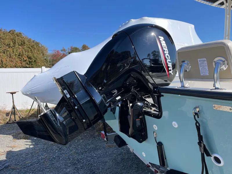 Slide: The Image of 2025 Boston Whaler 190 Montauk with Mercury outboard engine, parked outdoors. - 2