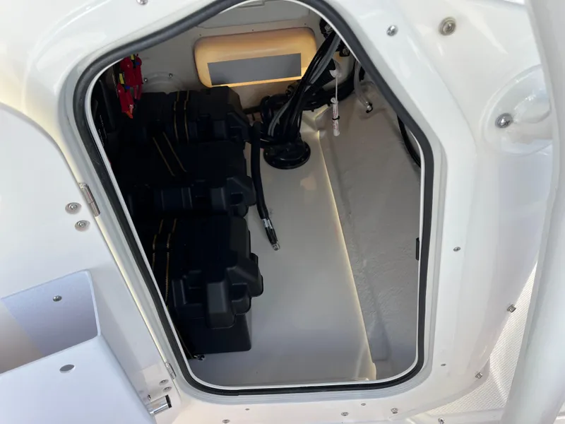 Slide: The Image of 2025 Boston Whaler 190 Montauk storage compartment with battery setup and wiring. - 20