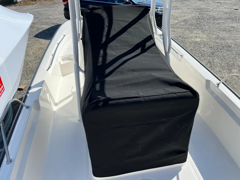 Slide: The Image of 2025 Boston Whaler 190 Montauk boat with black console cover on deck. - 25