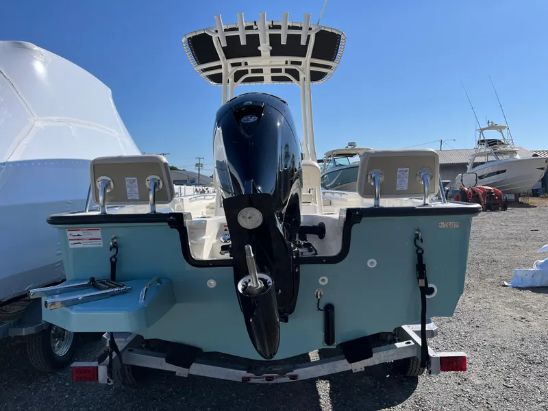 Slide: The Image of 2025 Boston Whaler 190 Montauk boat, rear view, on trailer, sunny day. - 29