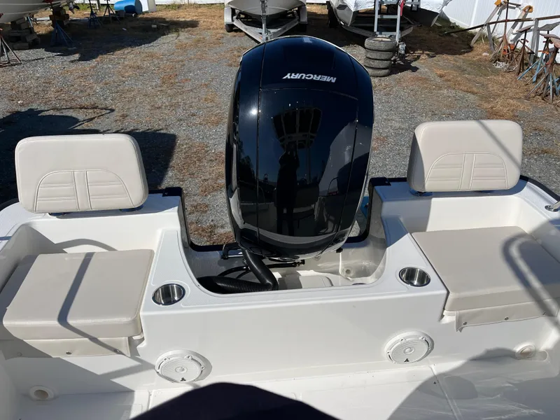 Slide: The Image of 2025 Boston Whaler 190 Montauk boat with Mercury engine, featuring comfortable seating and cup holders. - 7