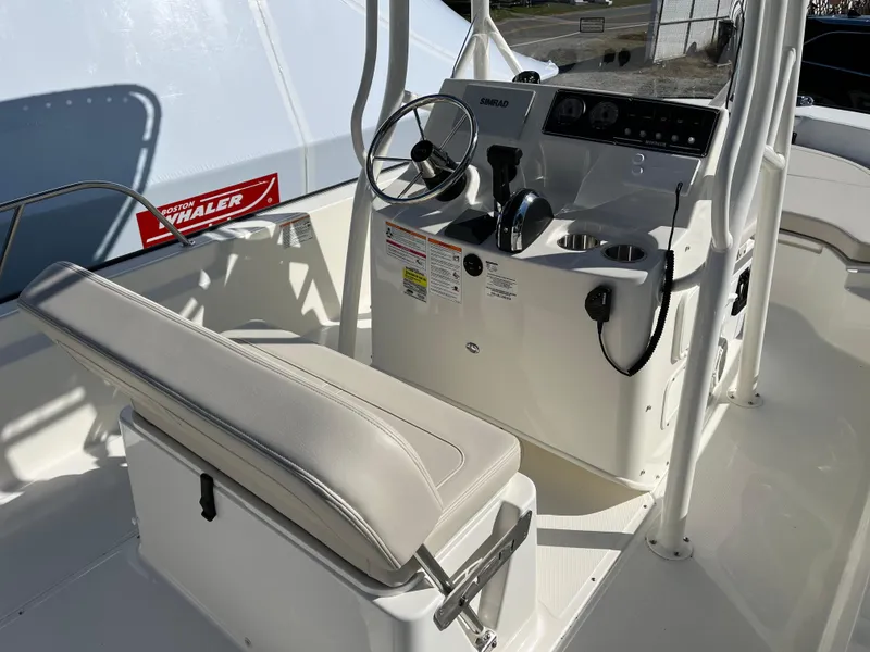 Slide: The Image of 2025 Boston Whaler 190 Montauk boat interior with steering console and seating. - 8