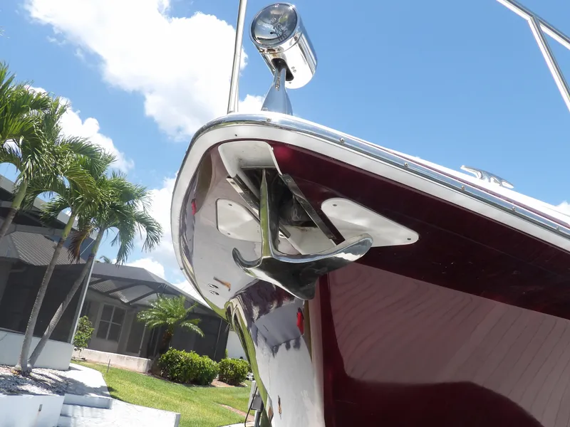 Slide: The Image of 2008 Formula 31 Performance Cruiser bow with anchor, docked near palm trees. - 11