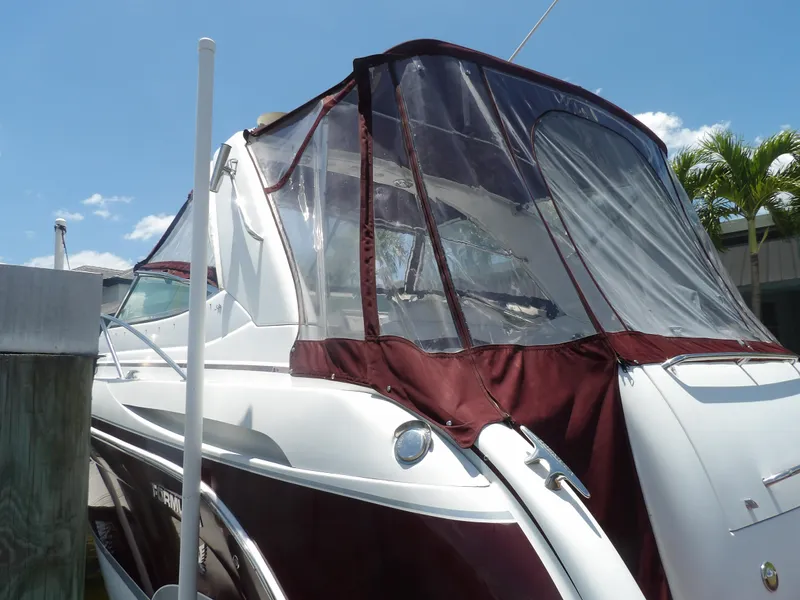 Slide: The Image of 2008 Formula 31 Performance Cruiser with maroon canvas cover docked. - 13