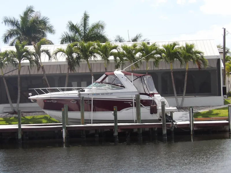 Slide: The Image of 2008 Formula 31 Performance Cruiser docked by palm trees. - 2