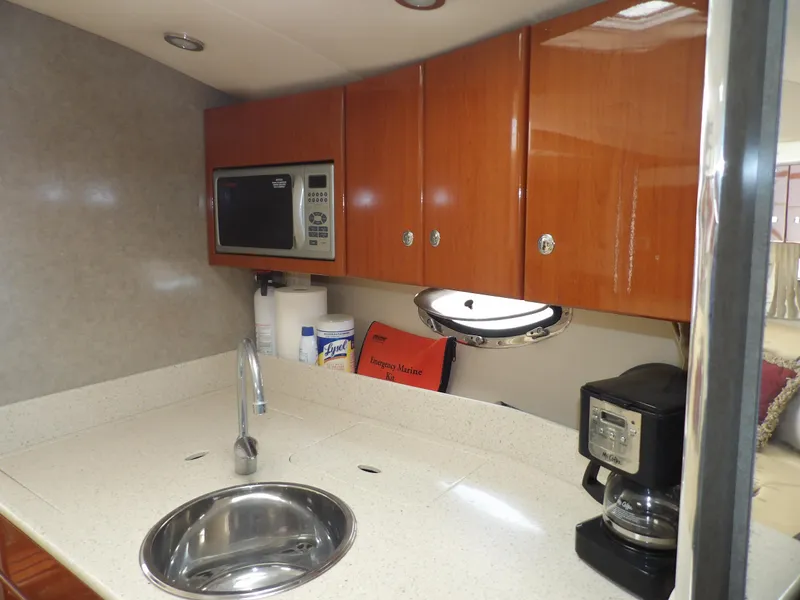 Slide: The Image of 2008 Formula 31 Performance Cruiser kitchen with microwave, sink, and coffee maker. - 44