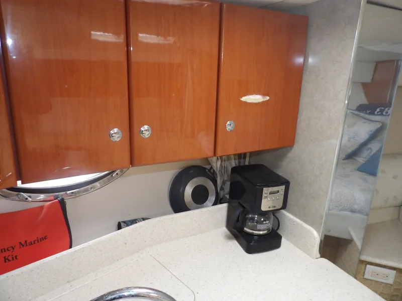 Slide: The Image of Interior of 2008 Formula 31 Performance Cruiser with wooden cabinets and coffee maker. - 47