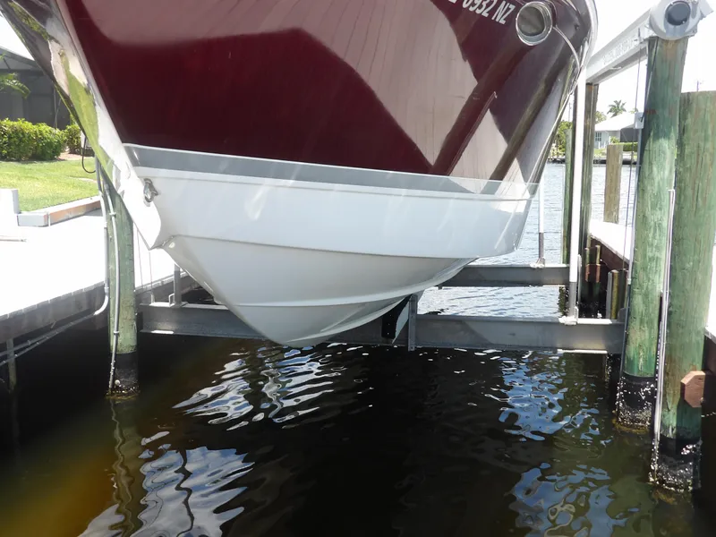 Slide: The Image of 2008 Formula 31 Performance Cruiser on a boat lift over water. - 6