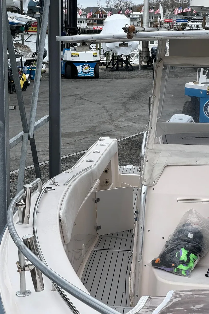 Slide: The Image of 1999 Grady-White 306 Bimini boat docked at a marina. - 10