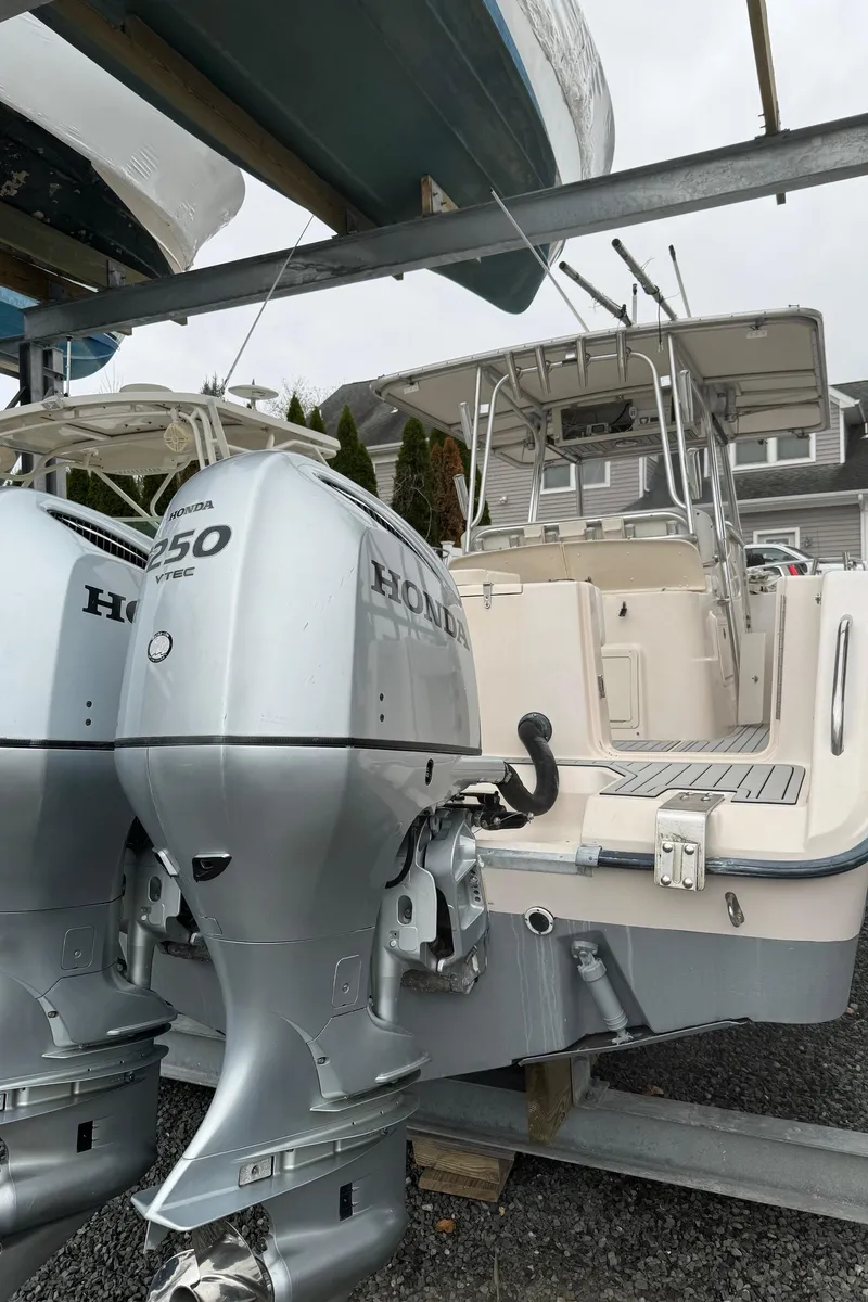 Slide: The Image of 1999 Grady-White 306 Bimini boat with twin Honda 250 outboard engines. - 12