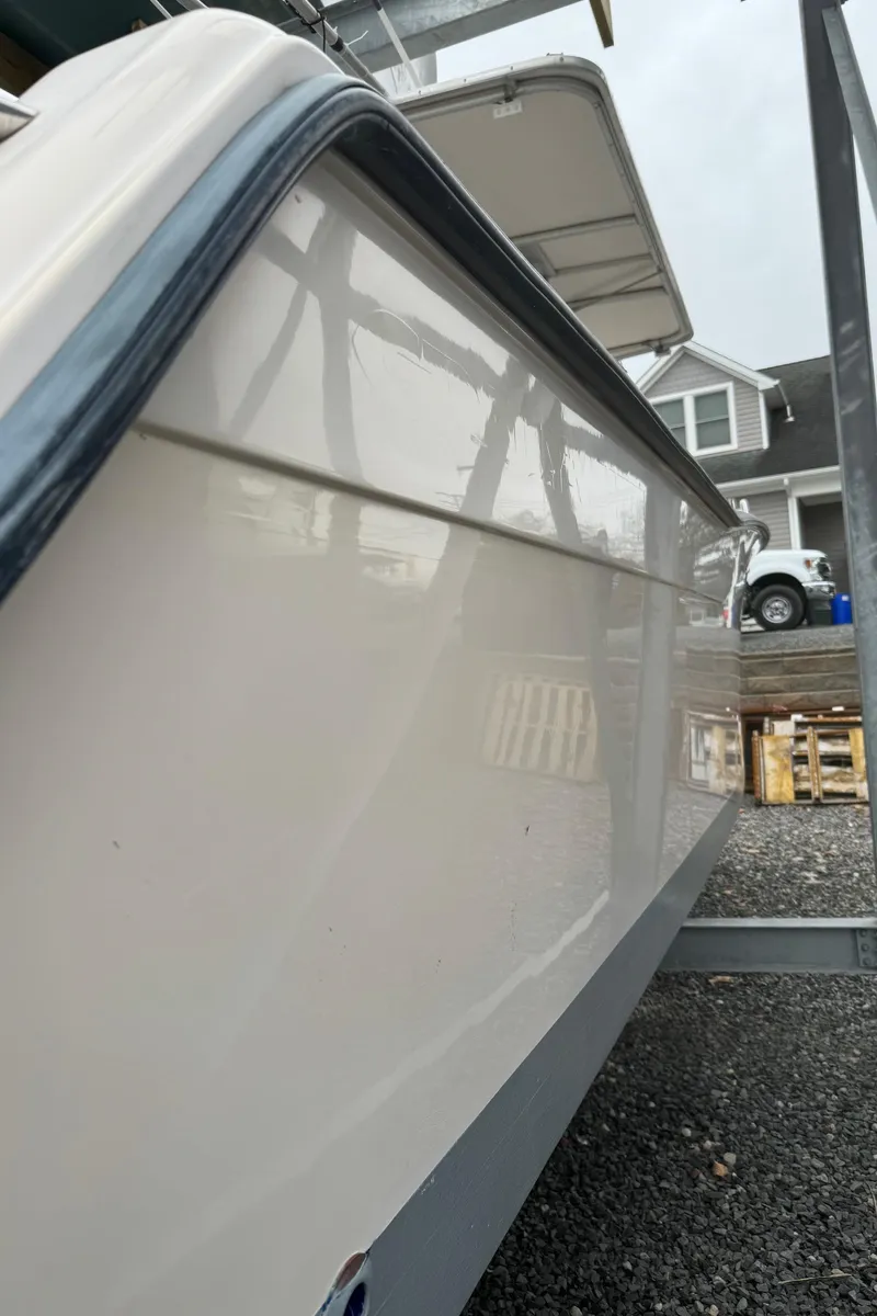 Slide: The Image of 1999 Grady-White 306 Bimini boat side view in a marina. - 13