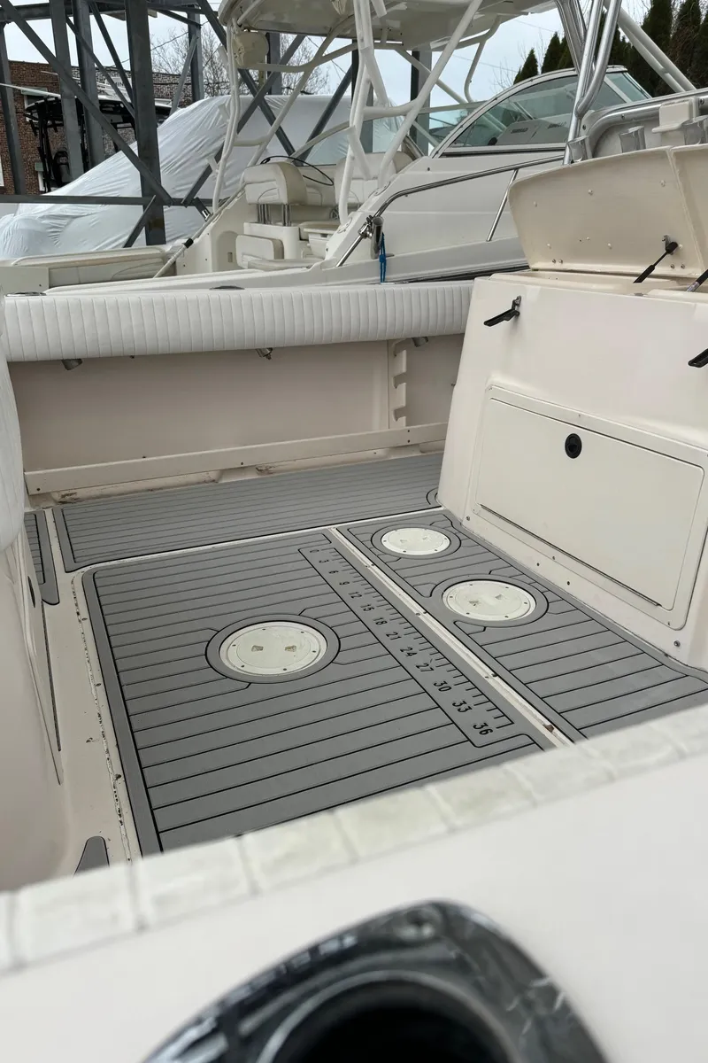 Slide: The Image of 1999 Grady-White 306 Bimini boat deck with storage compartments and seating. - 14