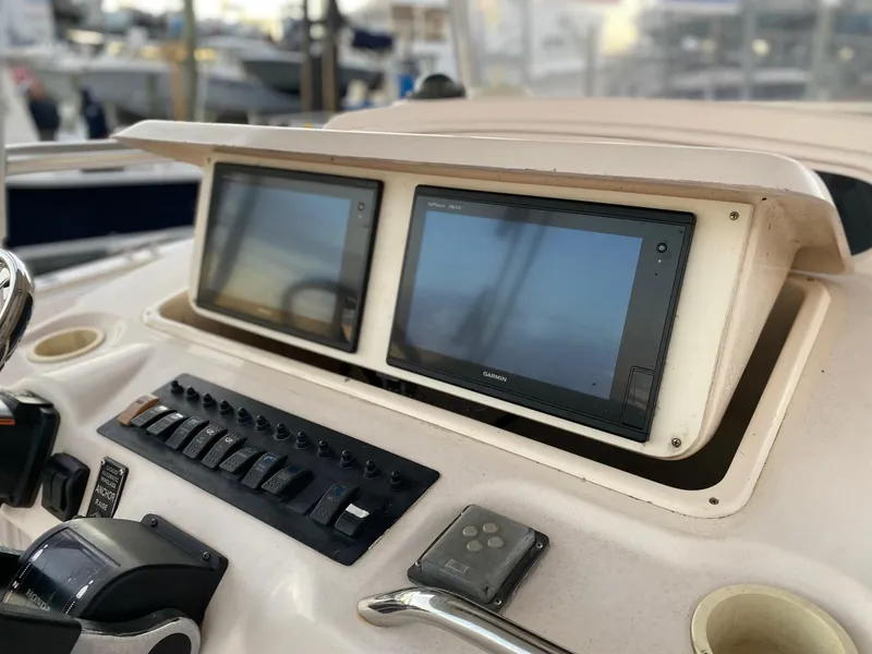 Slide: The Image of 1999 Grady-White 306 Bimini boat dashboard with dual Garmin displays. - 16