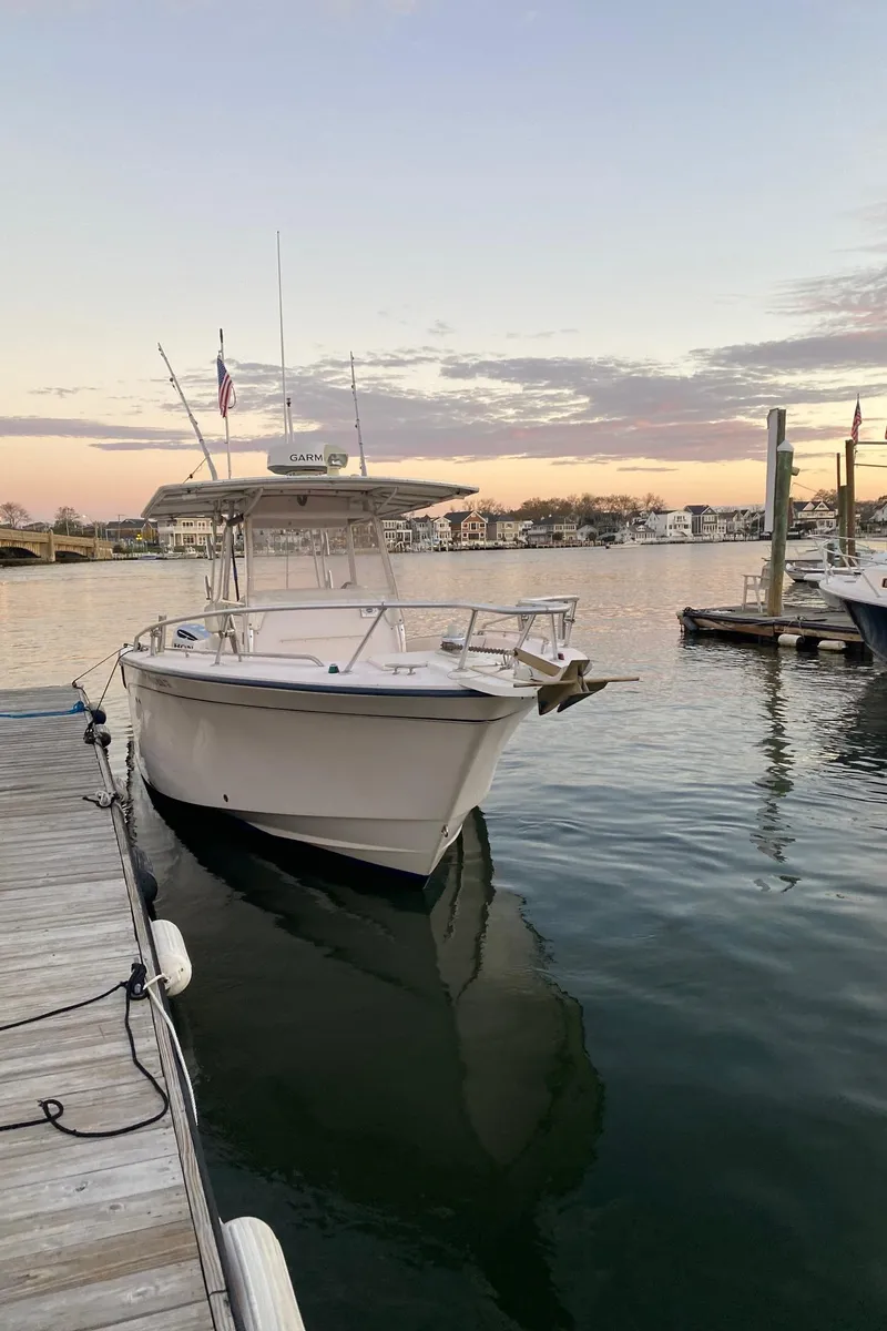 Slide: The Image of 1999 Grady-White 306 Bimini boat docked at sunset. - 3