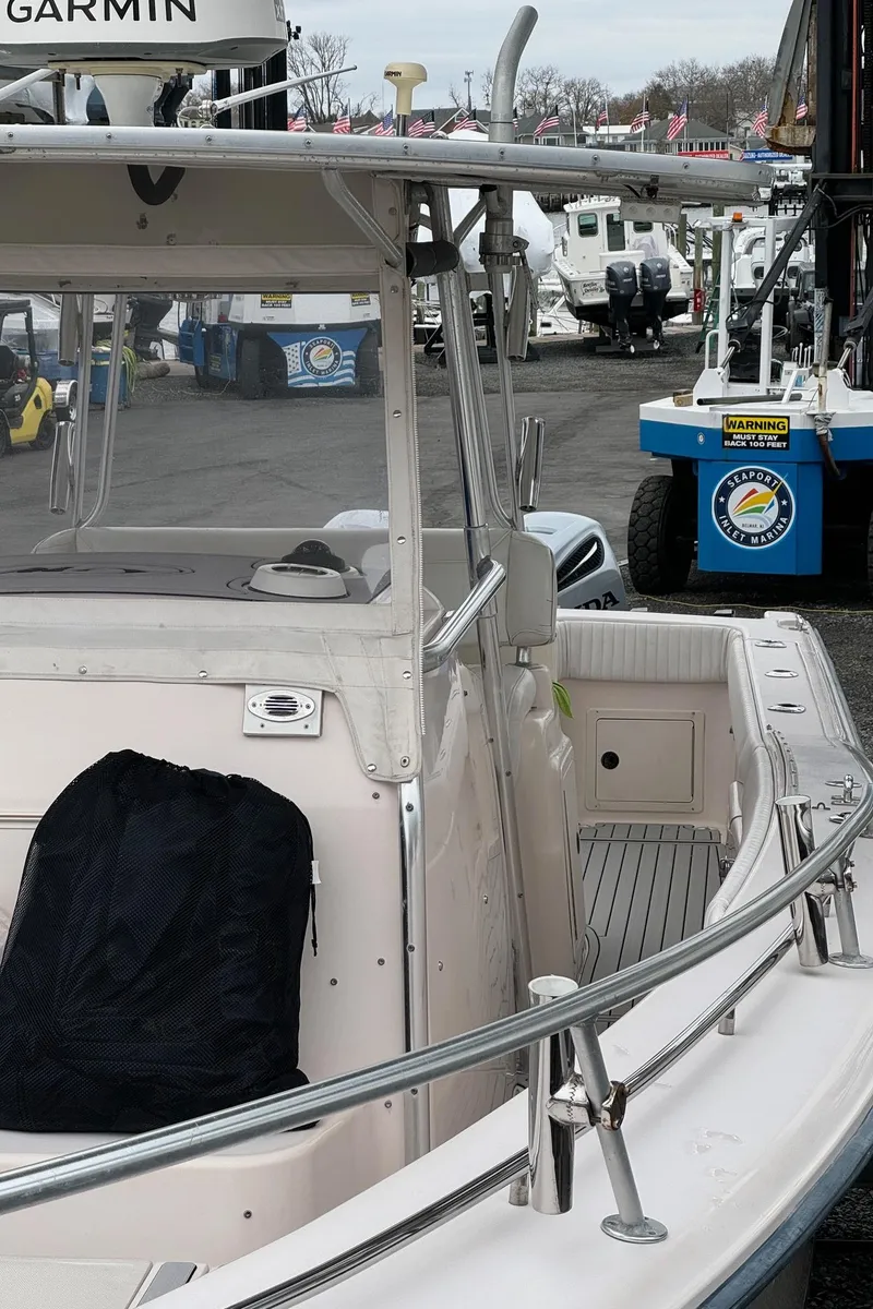Slide: The Image of 1999 Grady-White 306 Bimini boat at a marina, front view. - 9
