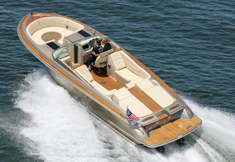 The Image of 2013 Chris-Craft Launch 32 boat cruising on water. - 0