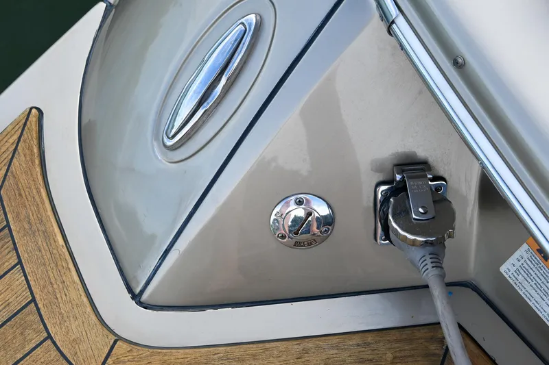 Slide: The Image of 2013 Chris-Craft Launch 32 interior with beige seating and wood flooring. - 11