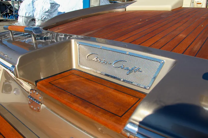 Slide: The Image of 2013 Chris-Craft Launch 32 boat interior with beige seating on a calm lake. - 17