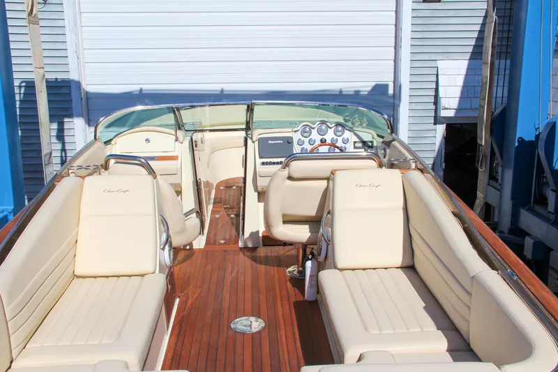 Slide: The Image of 2013 Chris-Craft Launch 32 boat under blue crane against clear sky. - 18