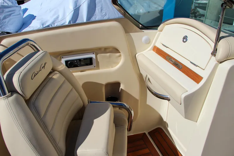 Slide: The Image of 2013 Chris-Craft Launch 32 boat interior with beige seating and wooden accents. - 21