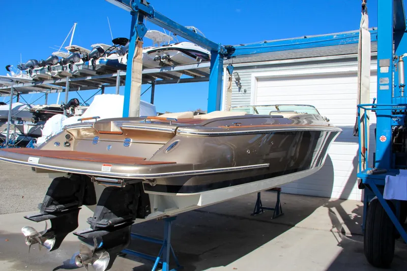 Slide: The Image of 2013 Chris-Craft Launch 32 interior with beige seating and wood accents. - 22