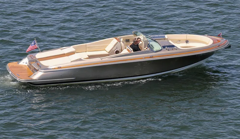 Slide: The Image of 2013 Chris-Craft Launch 32 boat cruising on water. - 3