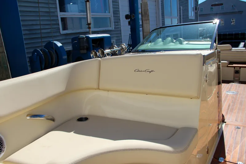 Slide: The Image of 2013 Chris-Craft Launch 32 boat interior with beige seating and wood flooring. - 30
