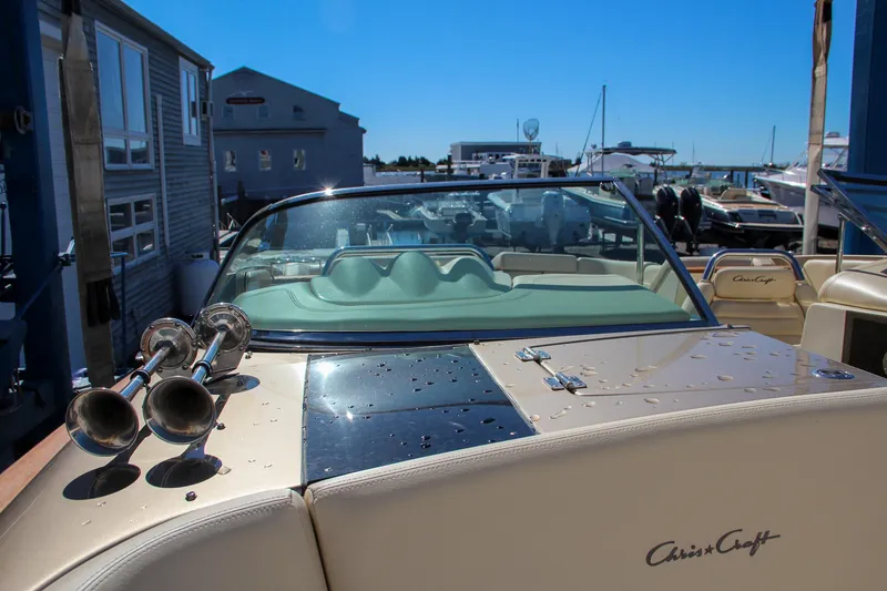 Slide: The Image of 2013 Chris-Craft Launch 32 boat interior with beige seating and wooden deck. - 31