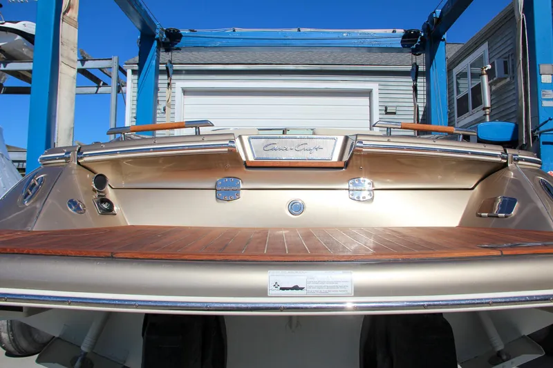 Slide: The Image of 2013 Chris-Craft Launch 32 boat interior with beige seating and wooden deck. - 35