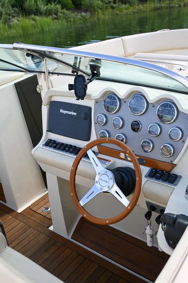 Slide: The Image of 2013 Chris-Craft Launch 32 boat cruising on water. - 39