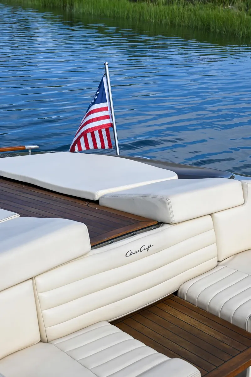 Slide: The Image of 2013 Chris-Craft Launch 32 boat with nautical flag on water. - 47