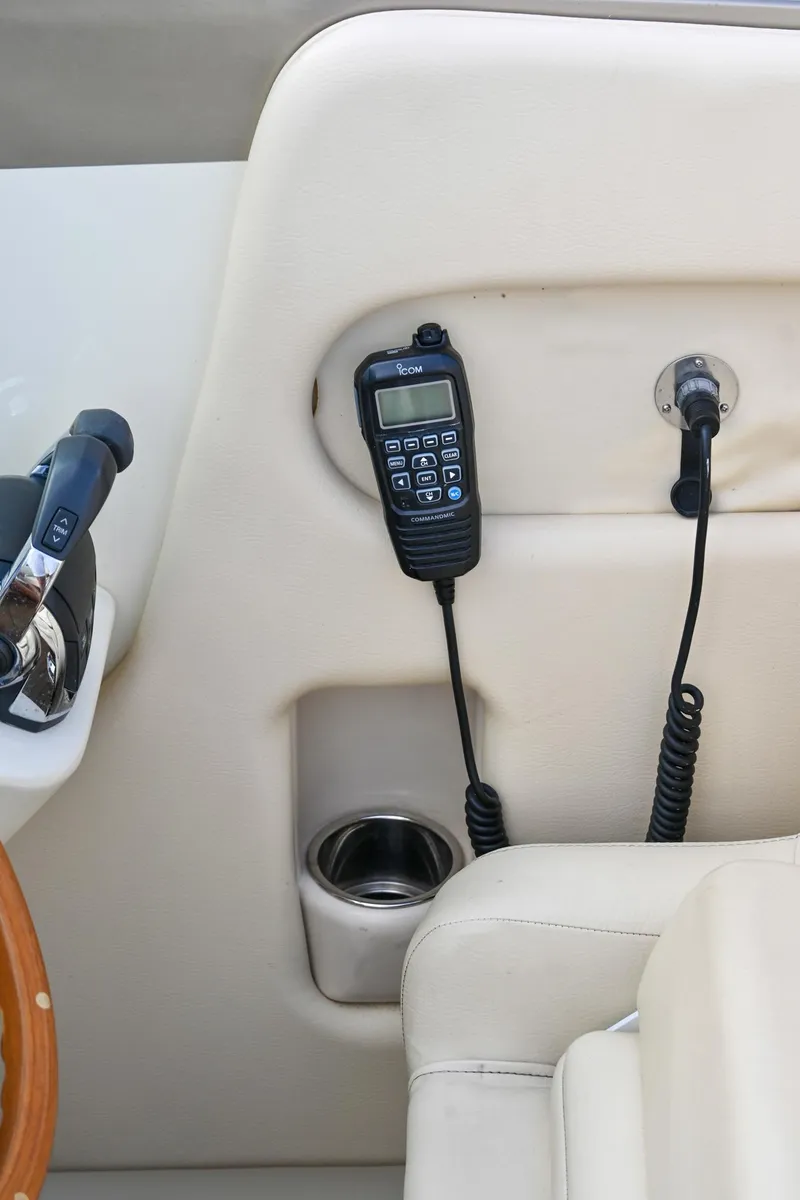 Slide: The Image of 2013 Chris-Craft Launch 32 boat interior with radio and cup holder. - 55