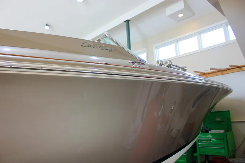 Slide: The Image of 2013 Chris-Craft Launch 32 boat in indoor storage, showcasing sleek design and craftsmanship. - 66