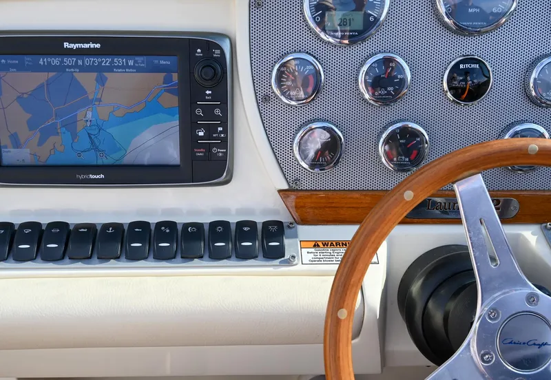Slide: The Image of Luxurious interior of 2013 Chris-Craft Launch 32 boat with elegant seating and wooden steering wheel. - 9