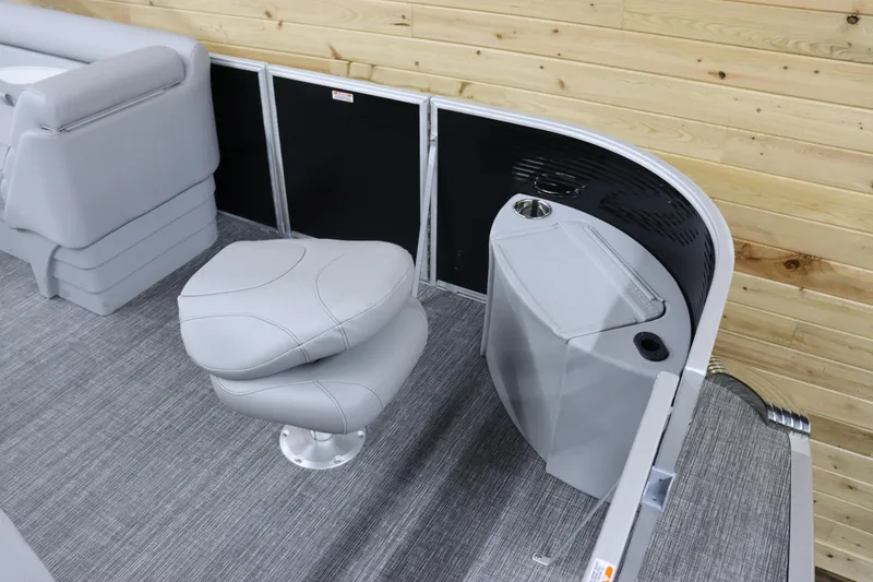 Slide: The Image of Bennington 20 SFNP 2024 boat interior with gray seating and wooden paneling. - 10