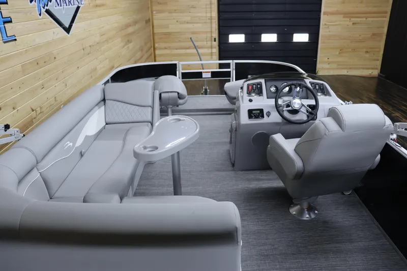 Slide: The Image of 2024 Bennington 20 SFNP boat interior with gray seating and steering console. - 14