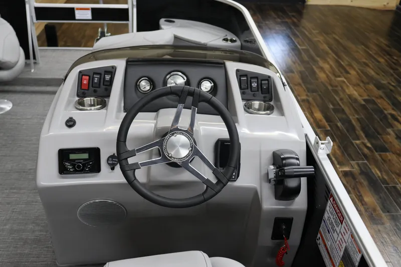 Slide: The Image of 2024 Bennington 20 SFNP boat dashboard with steering wheel and control panel. - 17