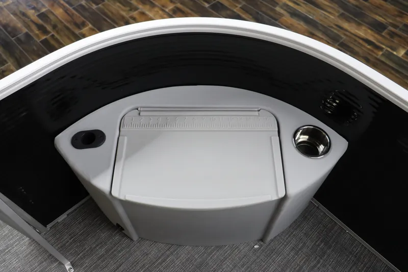 Slide: The Image of 2024 Bennington 20 SFNP boat console with cup holders and storage compartment. - 26