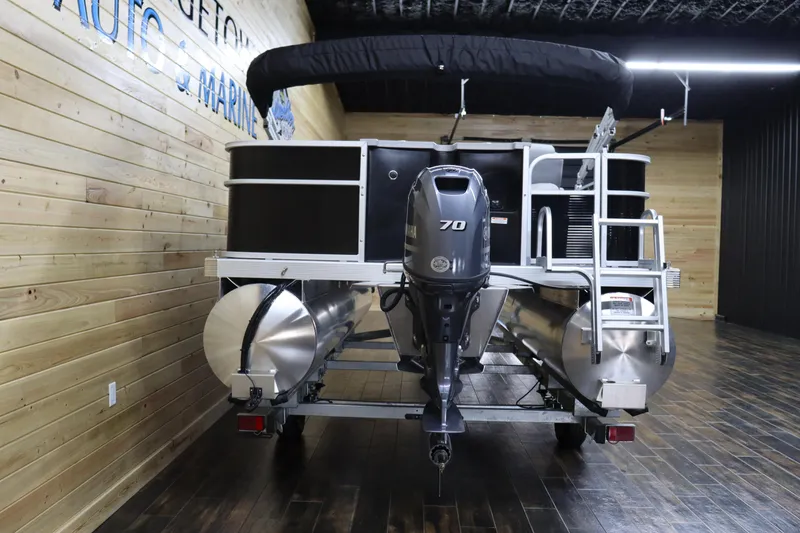 Slide: The Image of 2024 Bennington 20 SFNP pontoon boat with Yamaha 70 outboard motor in showroom. - 4