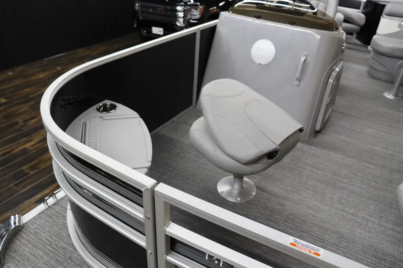 Slide: The Image of 2024 Bennington 20 SFNP pontoon boat interior with seating and console. - 9