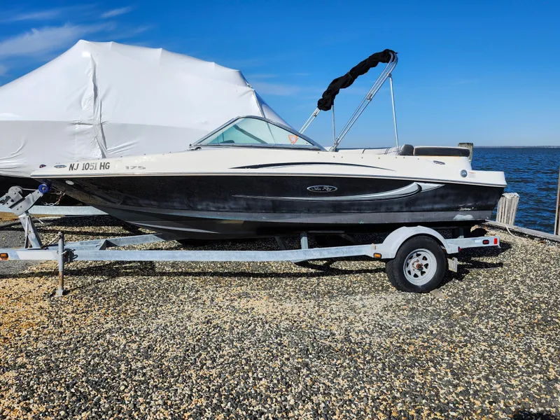 Slide: The Image of 2010 Sea Ray 175 Sport boat on trailer by the water. - 11