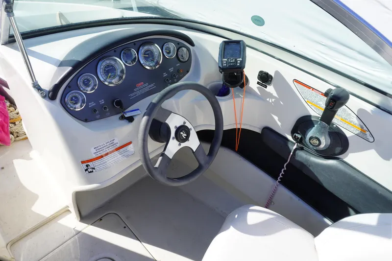 Slide: The Image of Dashboard of a 2010 Sea Ray 175 Sport boat with steering wheel and gauges. - 12