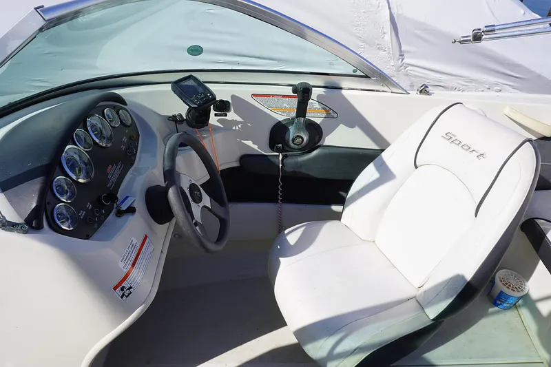 Slide: The Image of 2010 Sea Ray 175 Sport boat cockpit with steering wheel and control panel. - 13