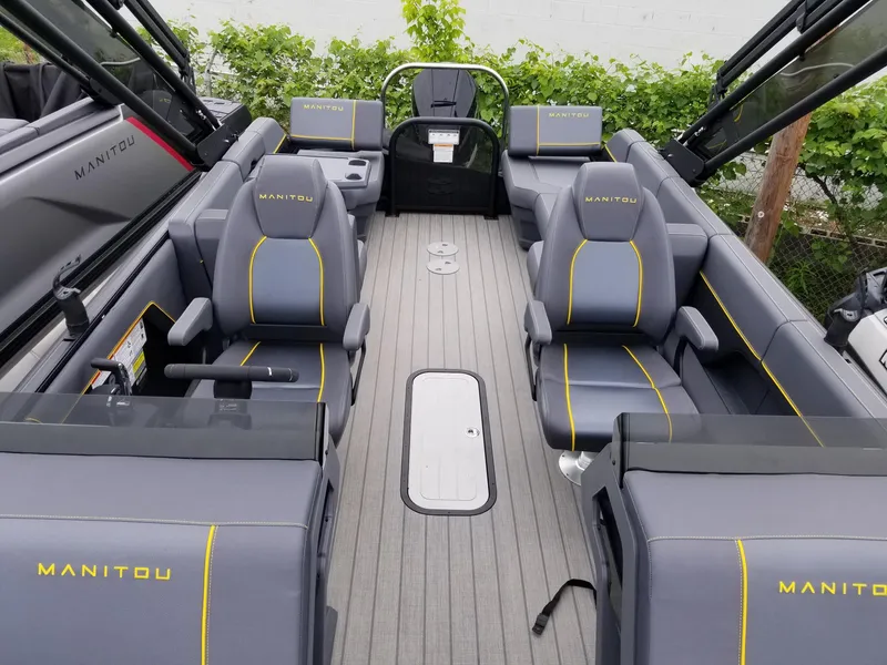Slide: The Image of 2023 Manitou Explore Navigator 24 with Trifold Bench - SHP575 interior, gray seating with yellow accents. - 3