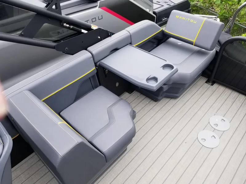 Slide: The Image of 2023 Manitou Explore Navigator 24 with Trifold Bench - SHP575, gray seating and table. - 6